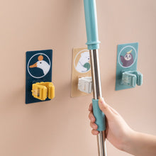 Self-adhesive wall mount for holding mops and brooms securely.