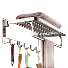 Wall-mounted stainless steel towel rack with a foldable design for bathroom storage.